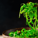 Fresh green sprouts on a black background.