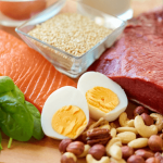 Variety of protein-rich foods including fish, nuts, eggs, and beans.