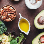 Assorted healthy foods, including nuts, avocado, and olive oil.