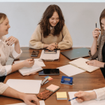 Group of people gathered around a table for a meeting.