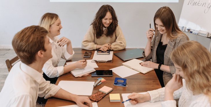 Group of people gathered around a table for a meeting.