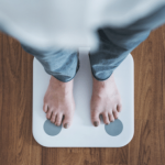 Person standing on a scale to check their weight.
