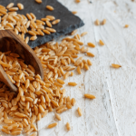 Grains scattered on a wooden surface.