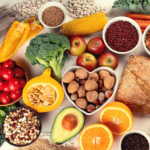 Variety of fruits, nuts, and vegetables displayed on a table.