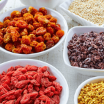 Assortment of dried fruits and nuts in containers.
