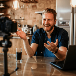 Man recording a video in a kitchen.