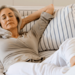 Woman relaxing on a couch with her eyes closed.