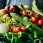 Fresh vegetables including tomatoes, cucumbers, and greens.