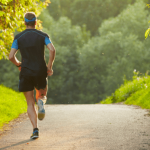 Man jogging on a forest path.