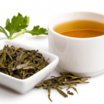 Green tea with fresh leaves and herbs.