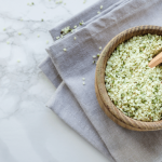 Small bowl of hemp seeds on a linen cloth.