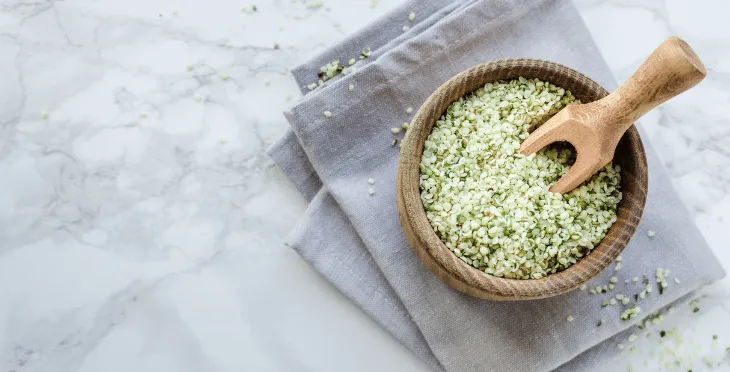 Small bowl of hemp seeds on a linen cloth.